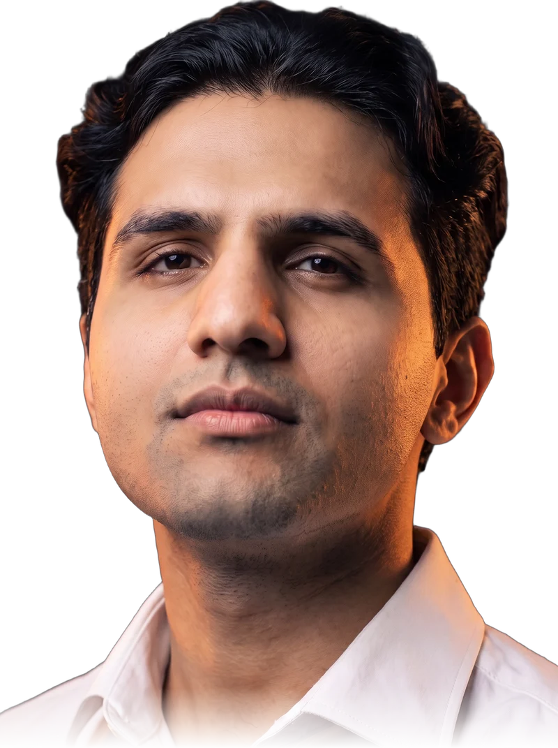 Rudra Khakhar, close-up studio portrait in a white shirt, looking just past the camera.